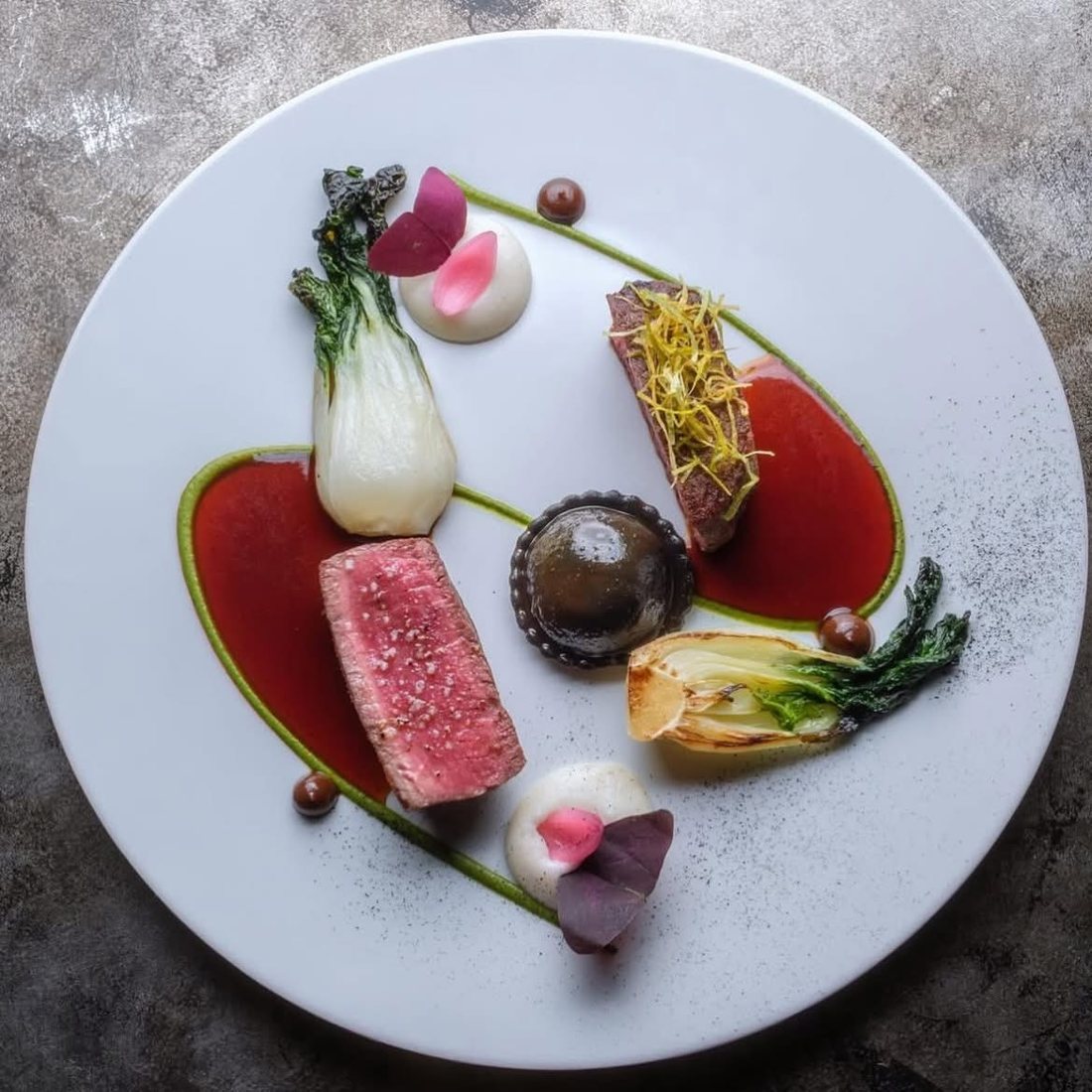 Beef two ways, bok choy and black raviolo